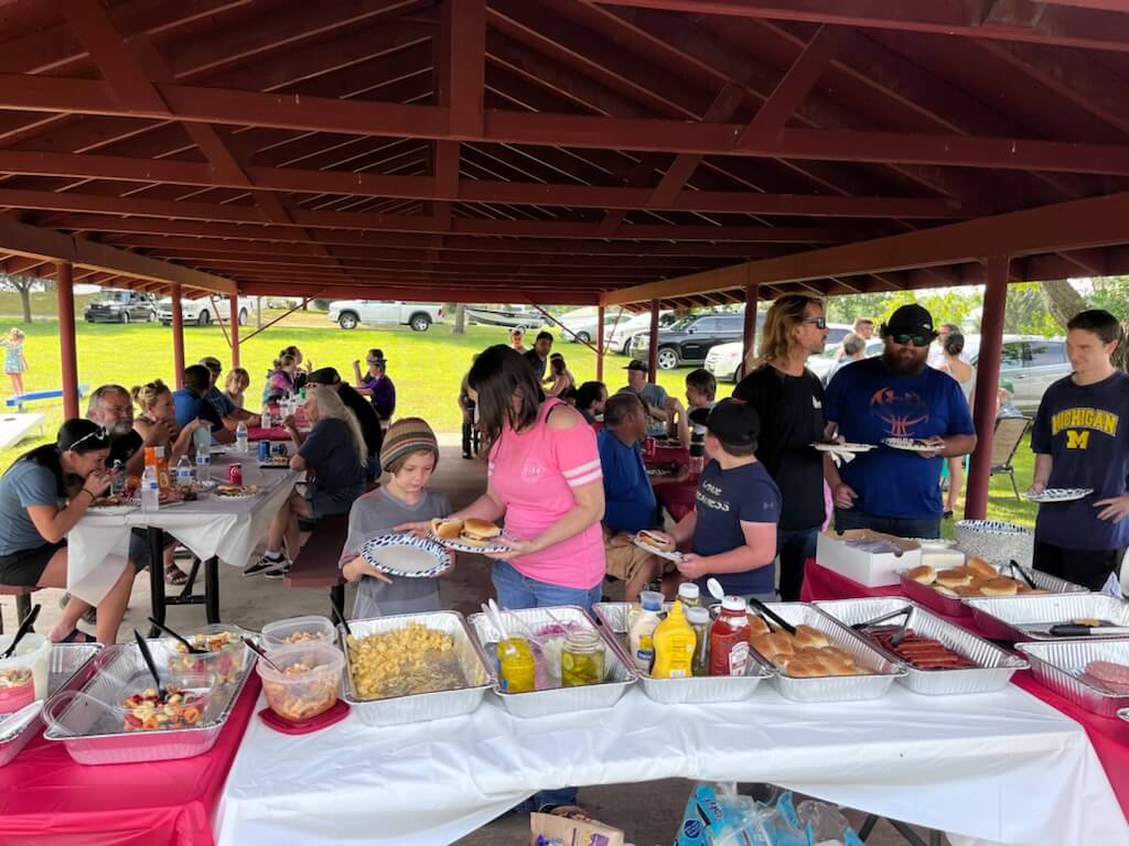 Darby Metal Treating employees and their families enjoying a luncheon in the park adjacent to the DMT facility.